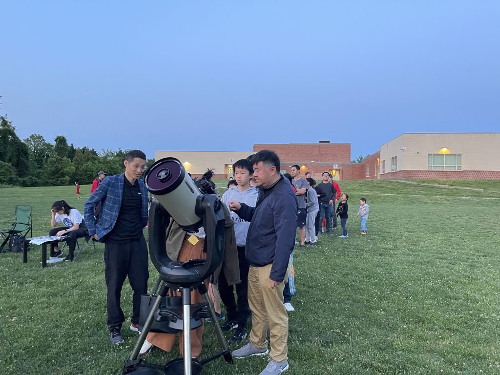 Residents lining up to view through telescopes at Kent Gardens Elementary School