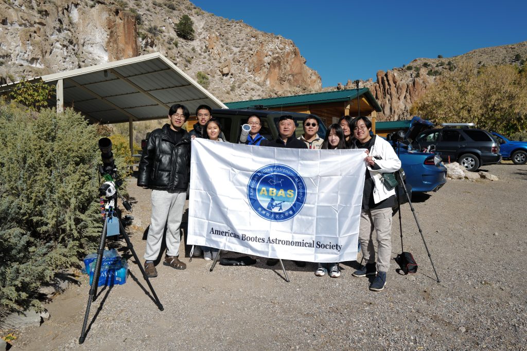 ABAS members posing with the society banner after observing the eclipse in Utah