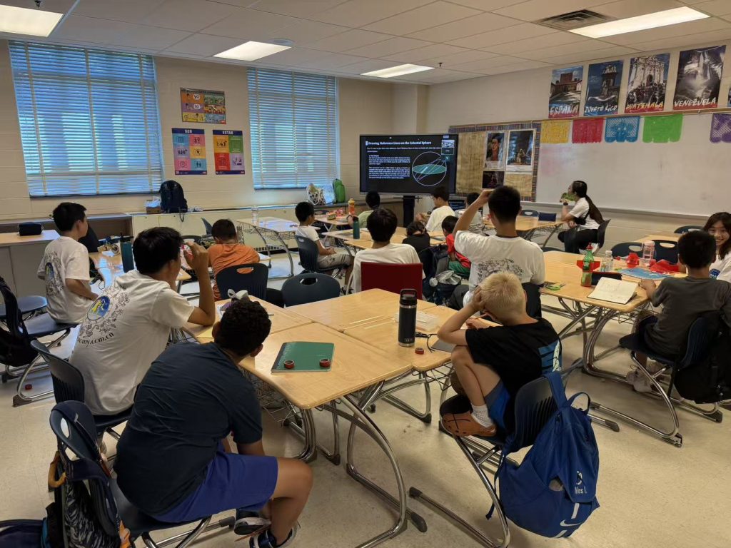 Campers in a classroom watching an astronomy presentation