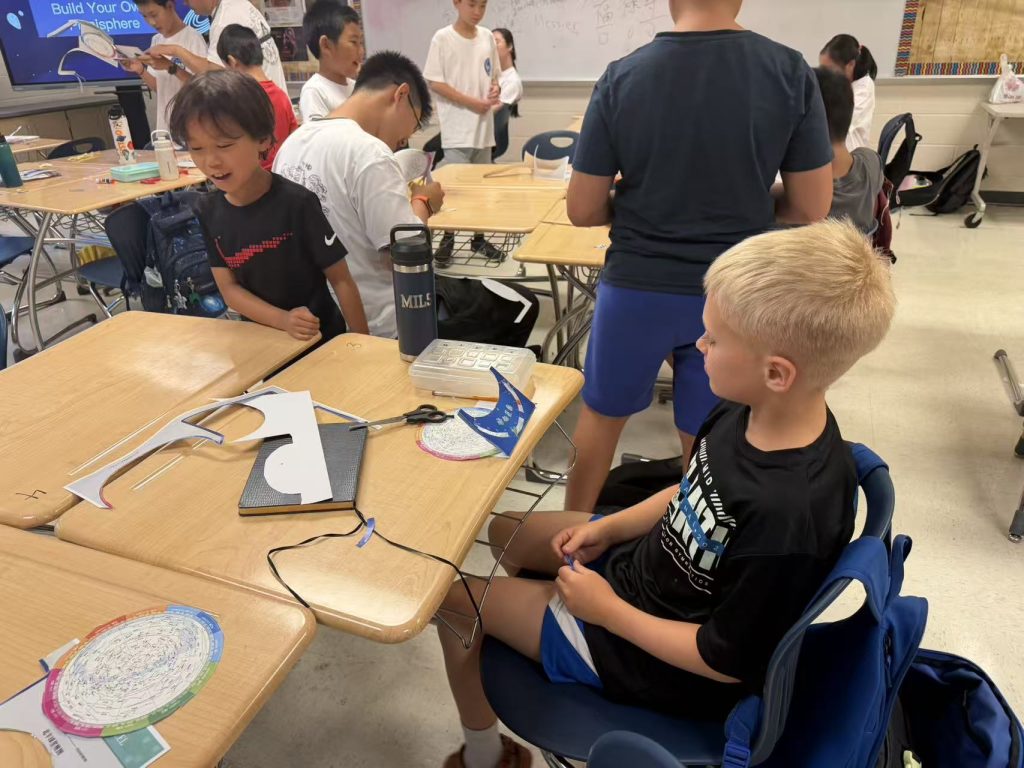 Campers cutting and assembling paper astronomy instruments